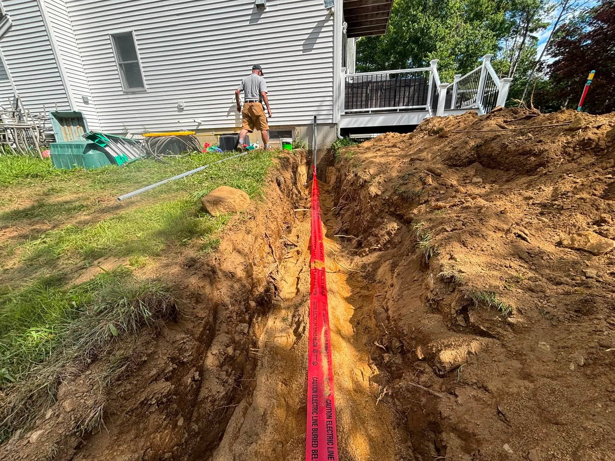 Open utility trench with caution tape — Brimfield, MA